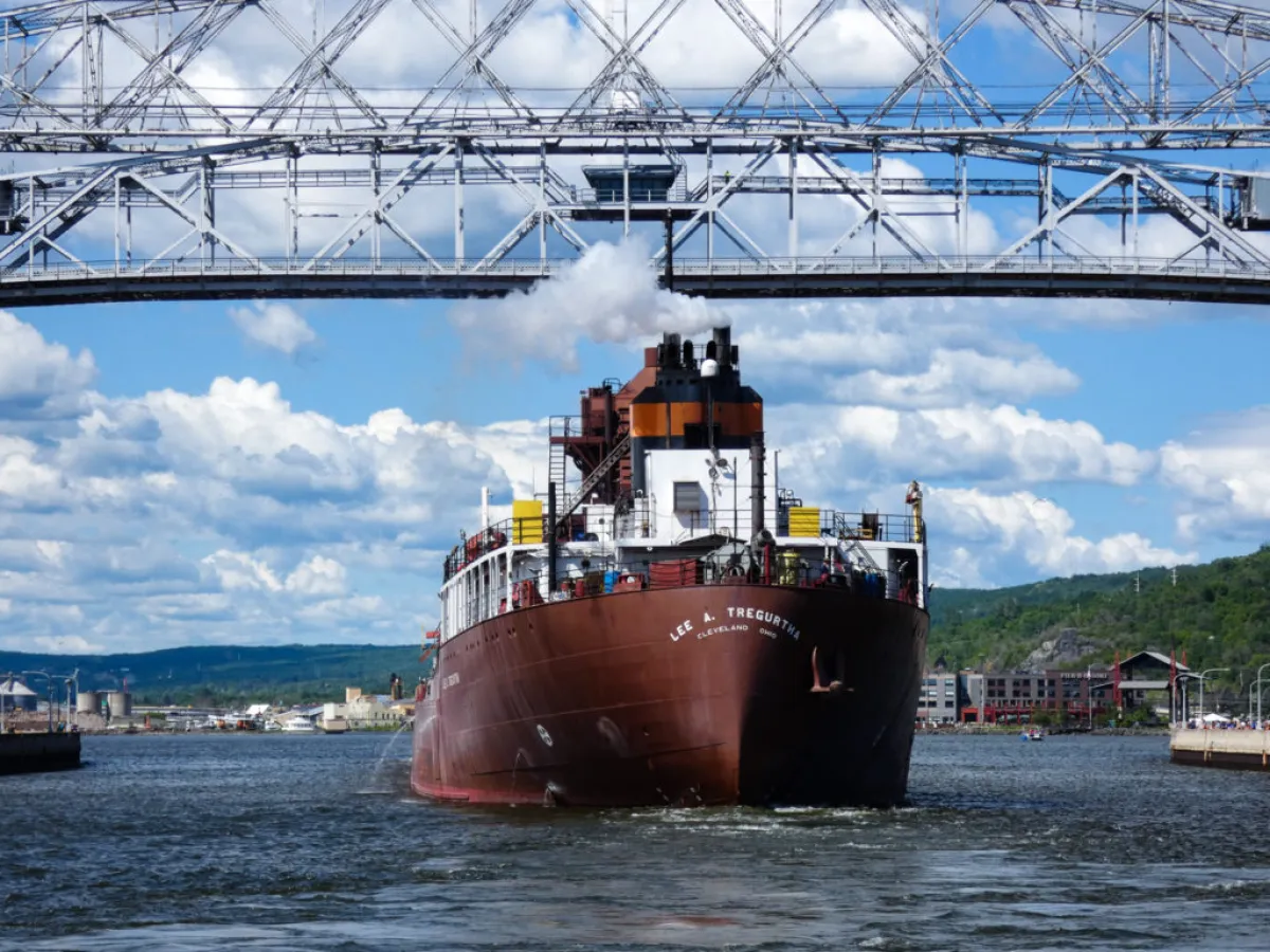 a boat traveling across a bridge over a body of water