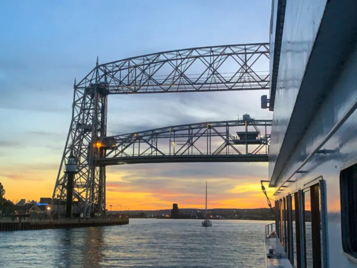 a train crossing a bridge over a body of water
