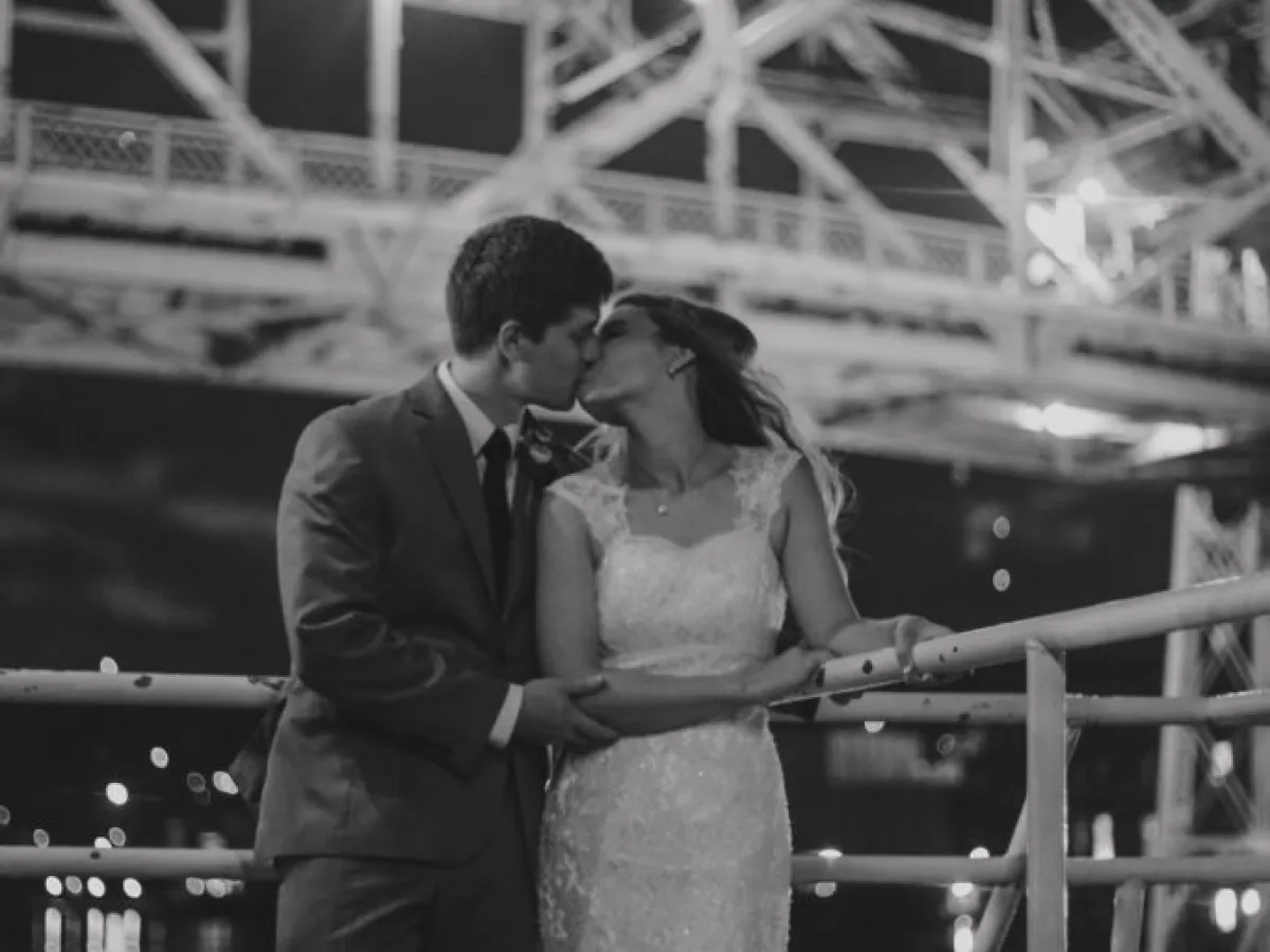 a man standing in front of a fence