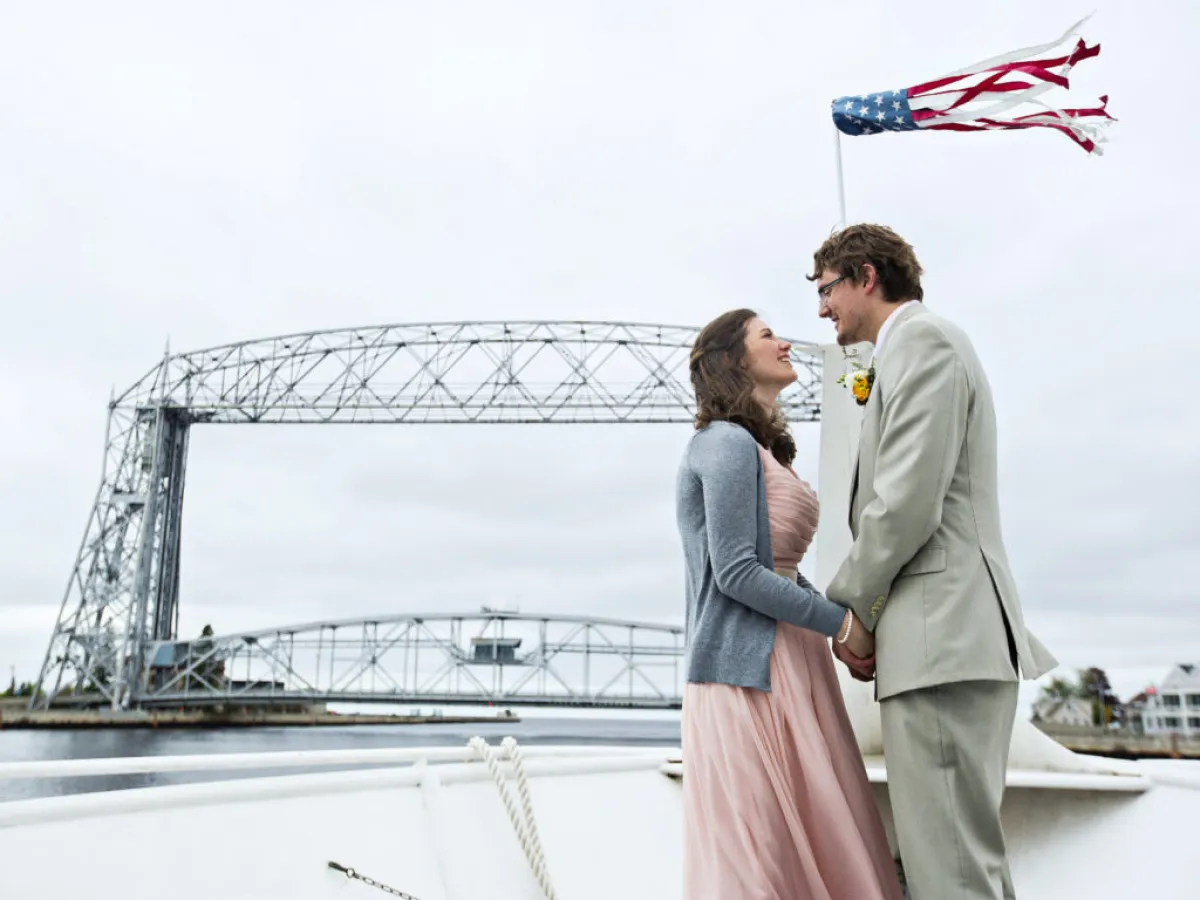 a man and a woman standing on a bridge