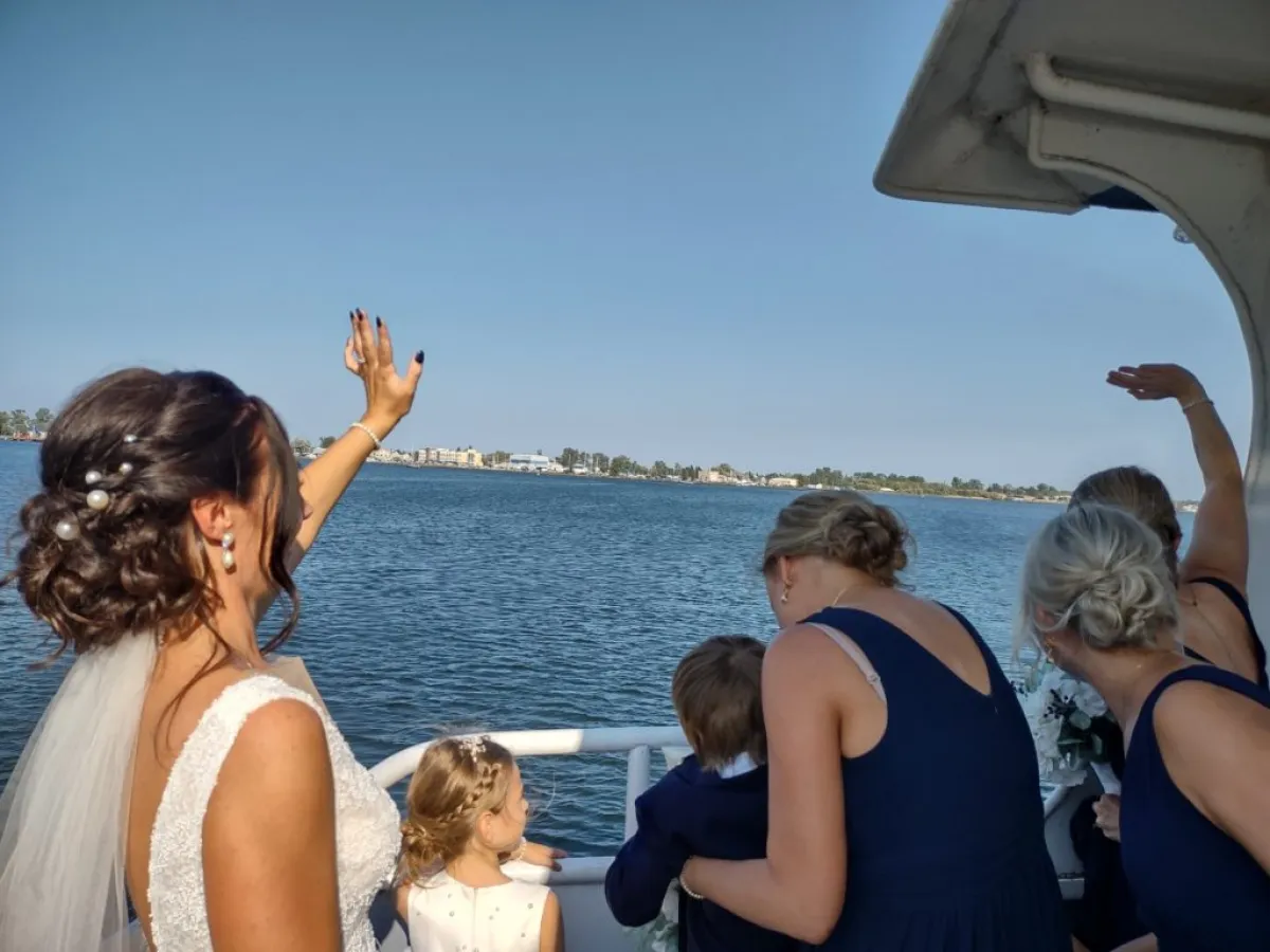 a group of people standing next to a body of water
