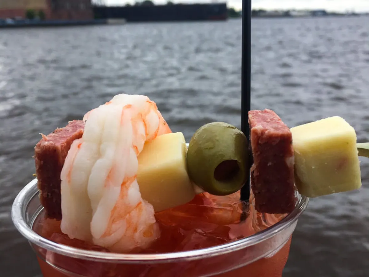 a close up of food on a table next to a cup of water