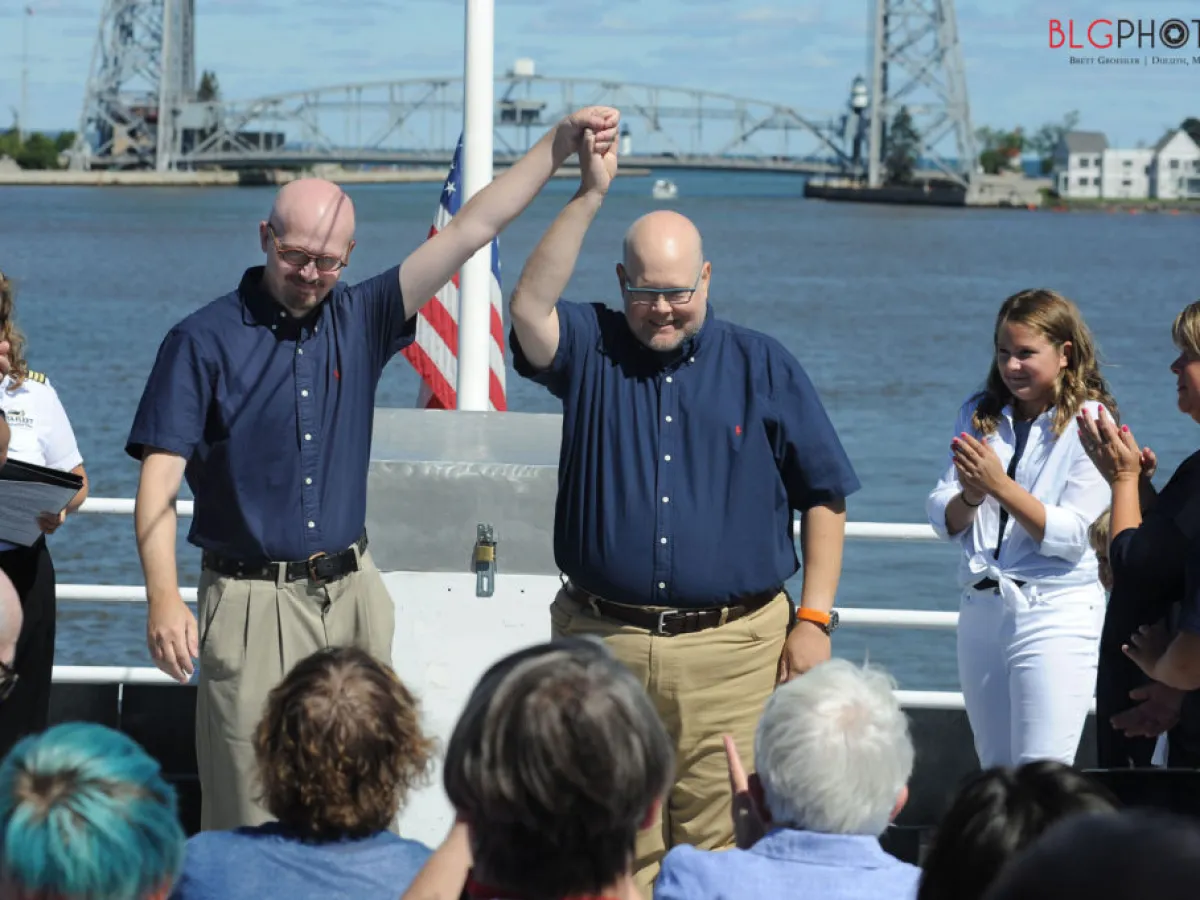 a group of people standing in front of a body of water