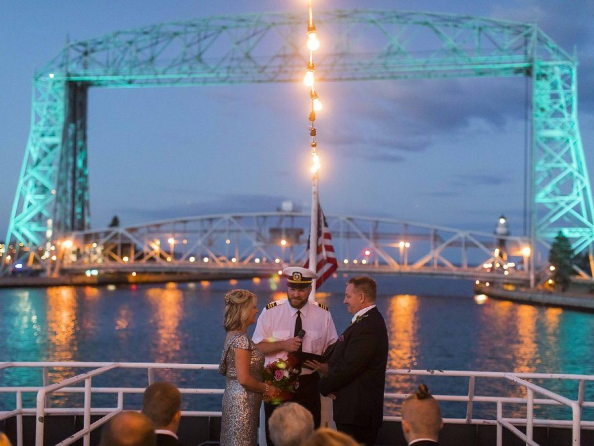 a group of people on a bridge over a body of water