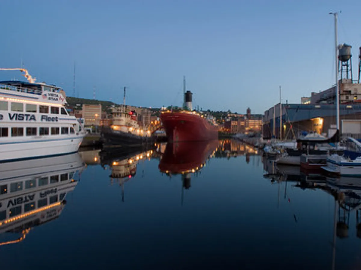 a boat is docked next to a body of water