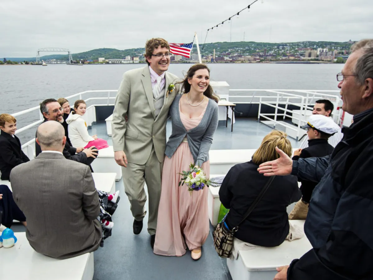 a group of people standing next to a body of water