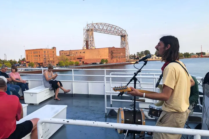 a group of people standing in front of a boat