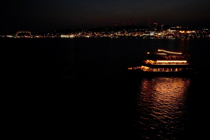 a large body of water with a city in the dark