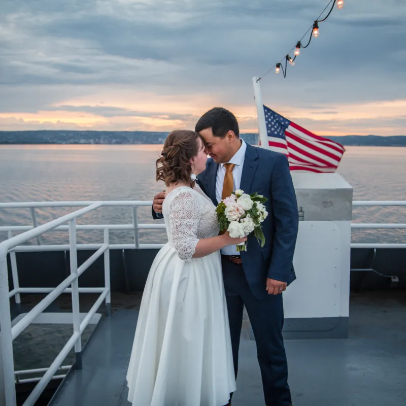 bride and groom leaning in for a kiss on a boat