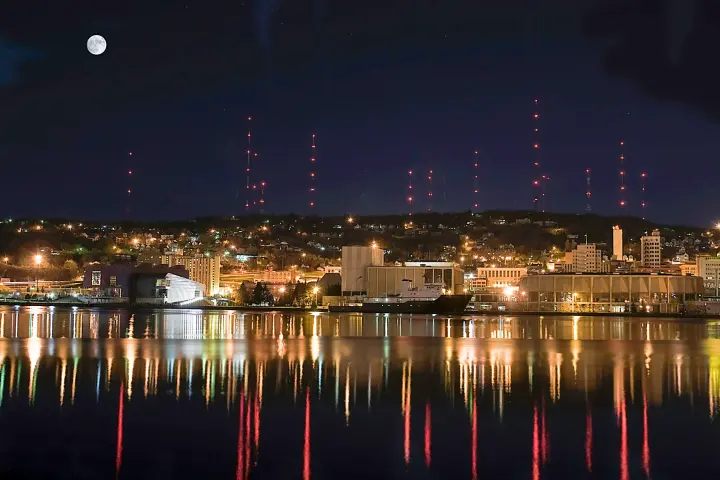 a body of water with a city in the night sky