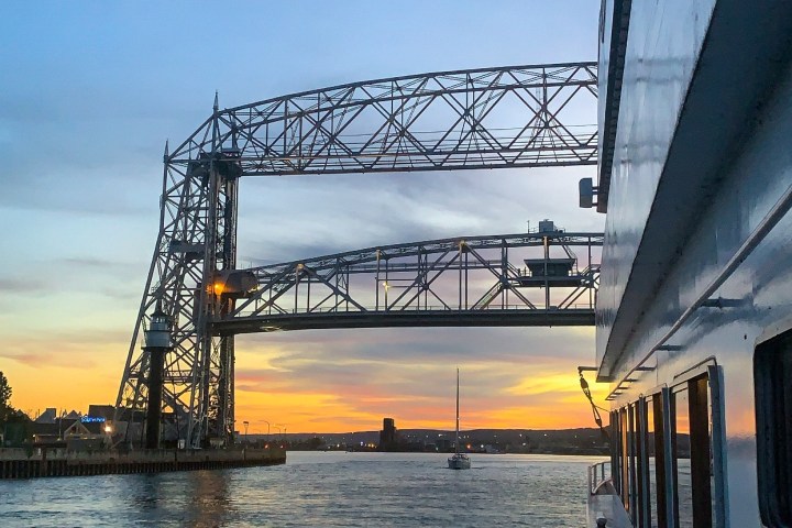 a train crossing a bridge over a body of water