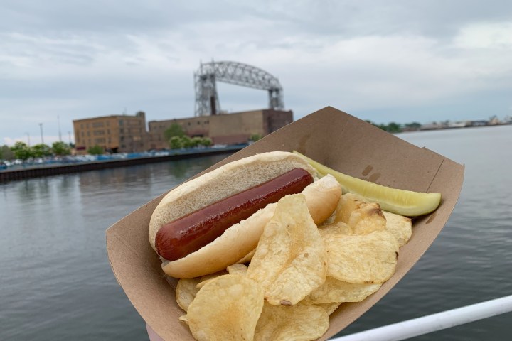 a hot dog lunch basket in Canal Park with the lake and lift bridge in the background